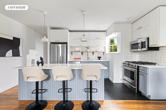 415 9th St Unit 41, New York City, NY 11215 - kitchen with stainless steel appliances, a sink, decorative backsplash, light countertops, and recessed lighting