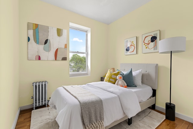 415 9th St Unit 41, New York City, NY 11215 - bedroom featuring radiator heating unit, wood finished floors, and baseboards