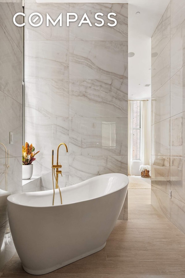 63 Greene St Unit 2D, New York City, NY 10012 - full bath with tile walls and a freestanding bath
