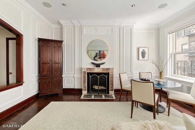 2 E 80th St Unit 7, New York City, NY 10075 - living area featuring a decorative wall, dark wood finished floors, ornamental molding, and a high end fireplace