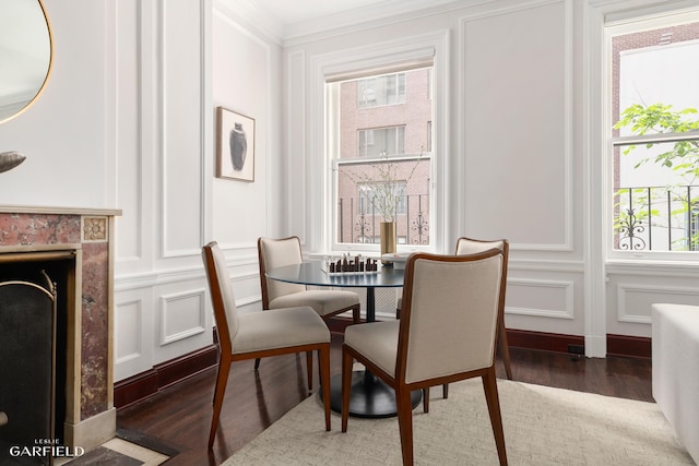 2 E 80th St Unit 7, New York City, NY 10075 - dining area featuring a decorative wall, wood finished floors, ornamental molding, and a premium fireplace