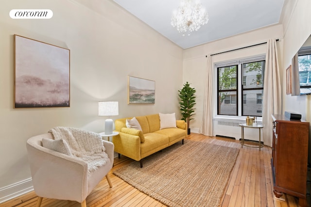 62 E 87th St Unit 1B, New York City, NY 10128 - living area featuring radiator heating unit, hardwood / wood-style flooring, a chandelier, and baseboards