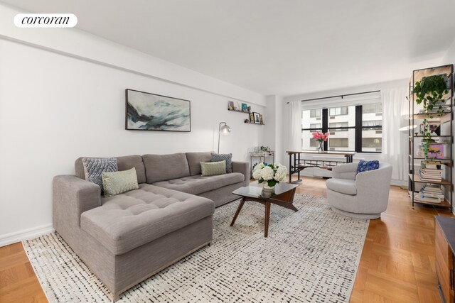 301 E 48th St Unit 6G, New York City, NY 10017 - living area featuring baseboards