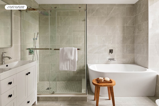 725 Quincy St, New York City, NY 11221 - full bathroom featuring tile walls, a freestanding tub, tile patterned flooring, vanity, and a shower stall