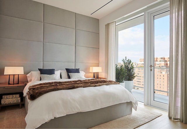 200 E 59th St Unit 15A, New York City, NY 10022 - bedroom featuring access to exterior and wood finished floors