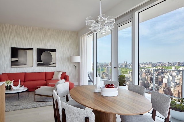 200 E 59th St Unit 26D, New York City, NY 10022 - dining area with a city view, wallpapered walls, wood finished floors, and a chandelier