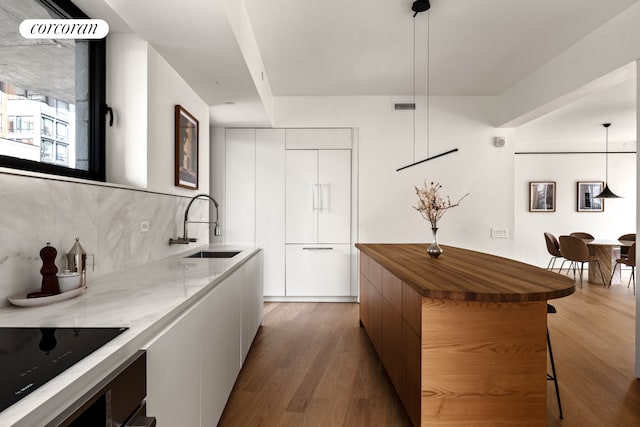 9 Chapel St Unit 9A, New York City, NY 11201 - kitchen with modern cabinets, a sink, wooden counters, decorative backsplash, and wood finished floors
