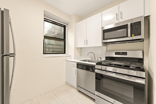 34-21 78th St Unit 1-H, New York City, NY 11372 - kitchen featuring stainless steel appliances, white cabinets, and light countertops