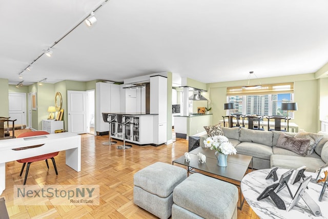 1175 York Ave Unit 16J, New York City, NY 10065 - living room featuring track lighting and baseboards
