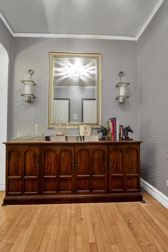222 E 35th St Unit 1-E, New York City, NY 10016 - bathroom featuring hardwood / wood-style flooring, crown molding, vanity, and wallpapered walls