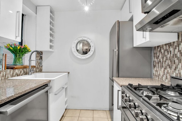 222 E 35th St Unit 1-E, New York City, NY 10016 - kitchen with appliances with stainless steel finishes, range hood, white cabinetry, and decorative backsplash
