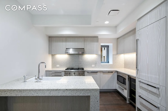 37 Warren St Unit 3C, New York City, NY 10007 - kitchen featuring exhaust hood, dark wood finished floors, stainless steel microwave, fridge, and modern cabinets
