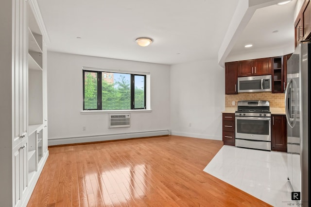 456 W 167th St Unit 2-A, New York City, NY 10032 - kitchen featuring appliances with stainless steel finishes, baseboard heating, light wood-type flooring, light countertops, and tasteful backsplash