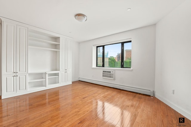 456 W 167th St Unit 2-A, New York City, NY 10032 - unfurnished bedroom with a baseboard radiator, light wood-style flooring, and a wall mounted AC