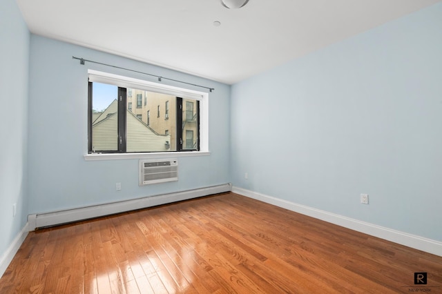 456 W 167th St Unit 2-A, New York City, NY 10032 - spare room featuring a baseboard radiator, wood finished floors, and a wall mounted AC