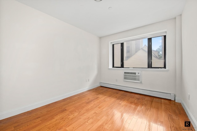 456 W 167th St Unit 2-A, New York City, NY 10032 - empty room featuring baseboard heating, light wood-style floors, and an AC wall unit