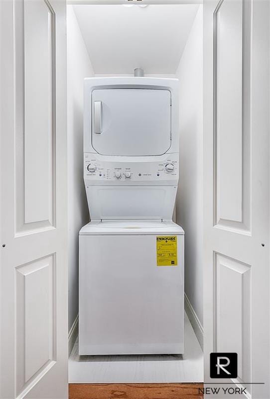 456 W 167th St Unit 2-A, New York City, NY 10032 - washroom featuring stacked washing machine and dryer and baseboards