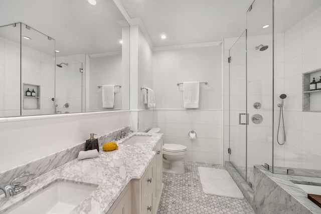 300 E 77th St Unit 10C, New York City, NY 10075 - bathroom with ornamental molding, double vanity, a shower stall, tile patterned floors, and recessed lighting