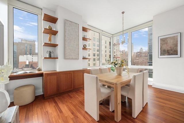 300 E 77th St Unit 10C, New York City, NY 10075 - dining space featuring light wood-style floors, a view of city, and a chandelier