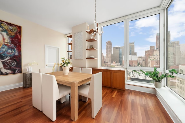 300 E 77th St Unit 10C, New York City, NY 10075 - dining space featuring light wood-type flooring, a city view, and a chandelier