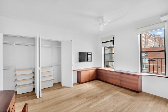 253 W 16th St Unit 6D, New York City, NY 10011 - unfurnished bedroom with two closets, light wood finished floors, a ceiling fan, and an office area