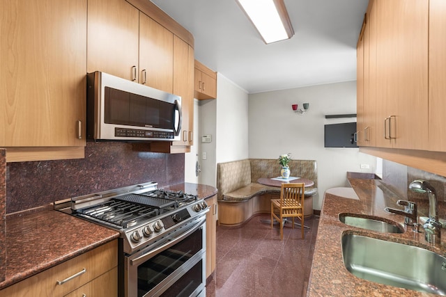 60 E End Ave Unit 27B, New York City, NY 10028 - kitchen featuring stainless steel appliances, light brown cabinetry, dark stone countertops, backsplash, and granite floors