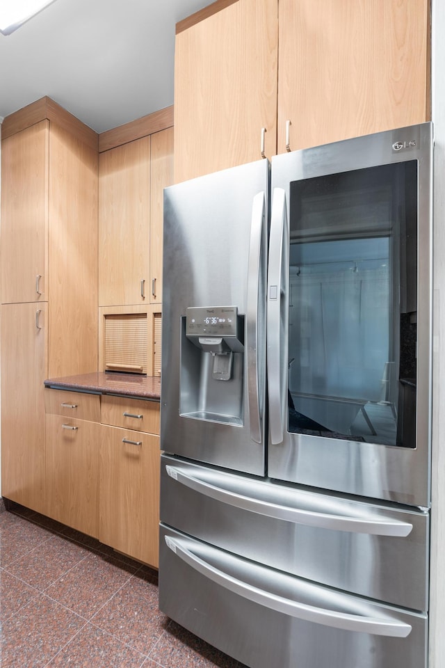 60 E End Ave Unit 27B, New York City, NY 10028 - kitchen featuring stainless steel refrigerator with ice dispenser, granite floors, light brown cabinetry, and stone countertops