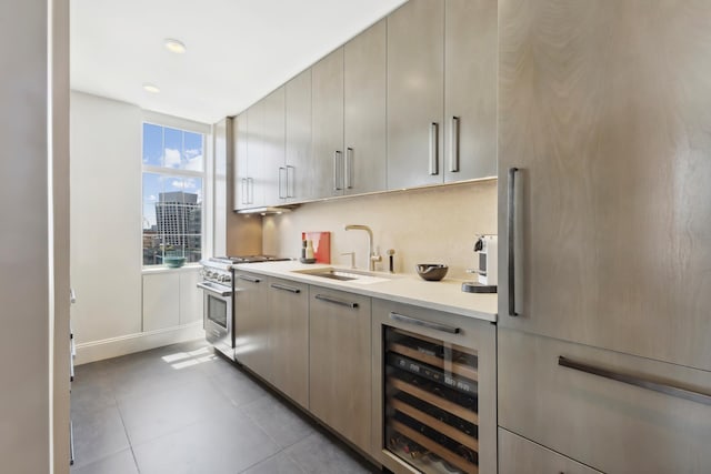 465 W 23rd St Unit 19D, New York City, NY 10011 - kitchen featuring high end stainless steel range, beverage cooler, a sink, fridge, and light countertops