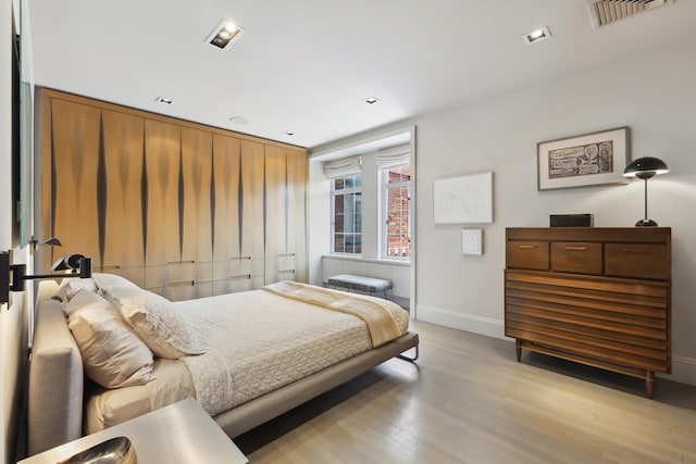465 W 23rd St Unit 19D, New York City, NY 10011 - bedroom with light wood finished floors and baseboards