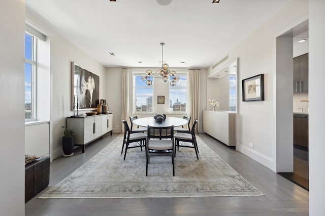 465 W 23rd St Unit 19D, New York City, NY 10011 - dining space with a chandelier, baseboards, and wood finished floors