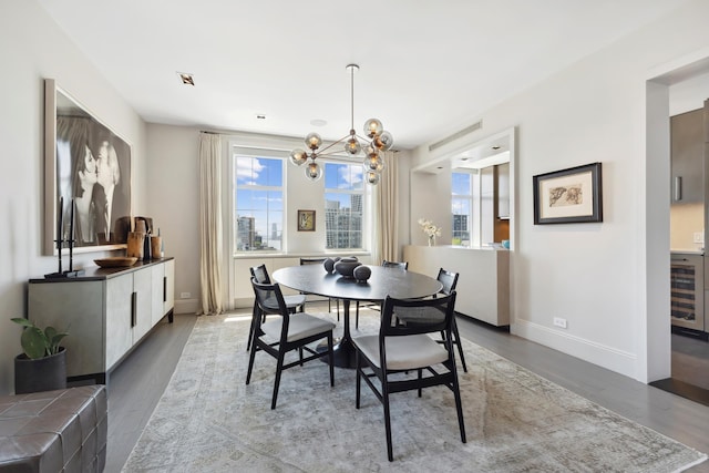465 W 23rd St Unit 19D, New York City, NY 10011 - dining area featuring wood finished floors, a chandelier, baseboards, and beverage cooler