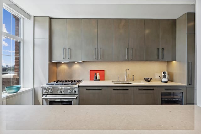 465 W 23rd St Unit 19D, New York City, NY 10011 - kitchen with stainless steel range, a sink, light countertops, and decorative backsplash