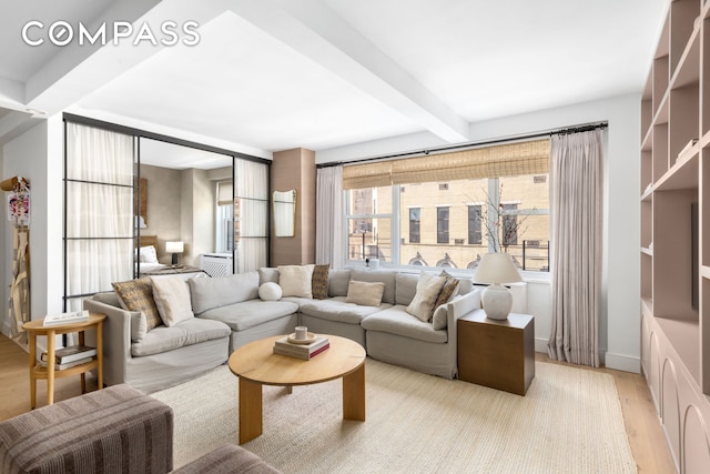 135 E 83rd St Unit 8/9C, New York City, NY 10028 - living area featuring beam ceiling and light wood-type flooring