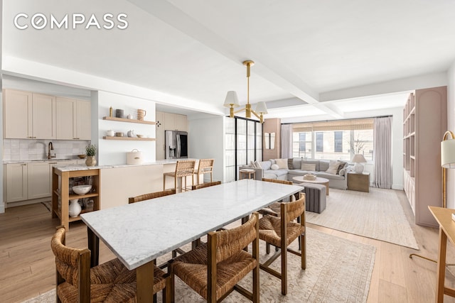 135 E 83rd St Unit 8/9C, New York City, NY 10028 - dining space with light wood-style flooring and beam ceiling