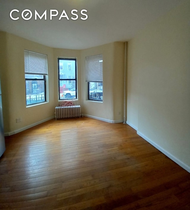 495 Linwood St, New York City, NY 11208 - home office featuring wood finished floors and radiator