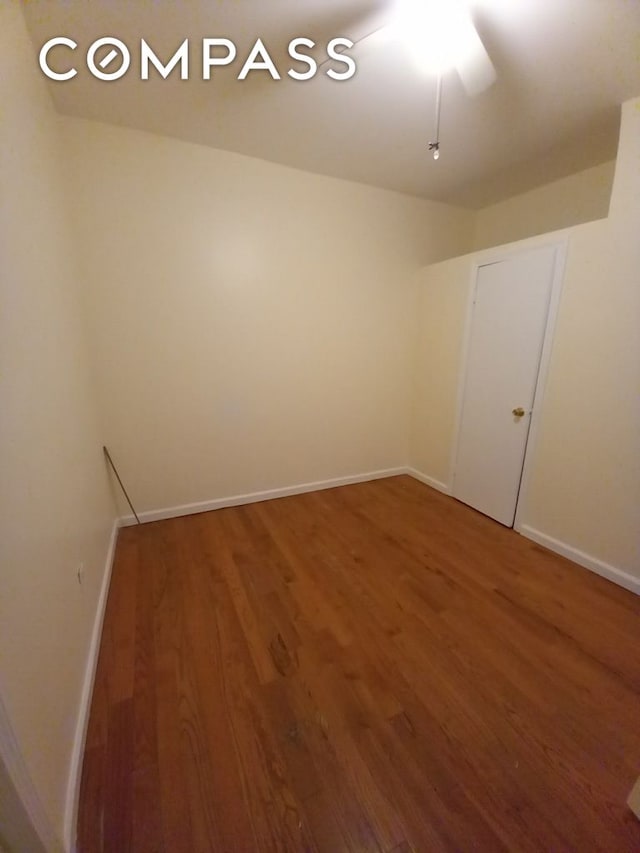 495 Linwood St, New York City, NY 11208 - bedroom featuring wood finished floors, an office area, and baseboards
