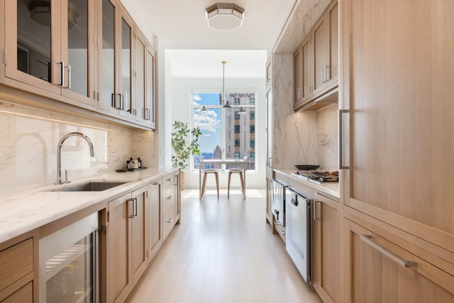 30 Park Pl Unit 60B, New York City, NY 10007 - kitchen with a sink, backsplash, light wood finished floors, light stone counters, and glass insert cabinets