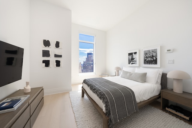 30 Park Pl Unit 60B, New York City, NY 10007 - bedroom with light wood-style flooring and vaulted ceiling