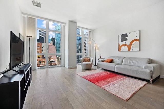 305 E 51st St Unit 20-B, New York City, NY 10022 - living room featuring wood finished floors and floor to ceiling windows