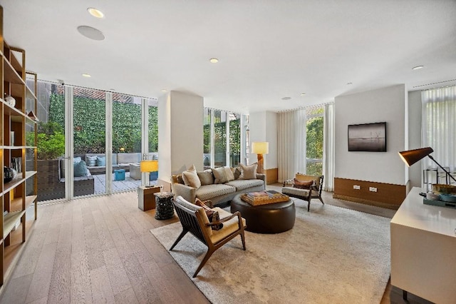 305 E 51st St Unit 20-B, New York City, NY 10022 - living area with light wood finished floors and a wall of windows