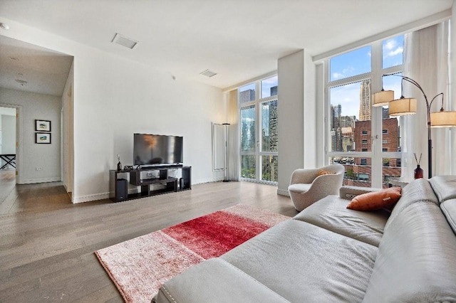 305 E 51st St Unit 20-B, New York City, NY 10022 - living area featuring wood finished floors and baseboards