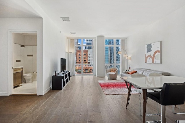 305 E 51st St Unit 20-B, New York City, NY 10022 - living room featuring wood finished floors and floor to ceiling windows