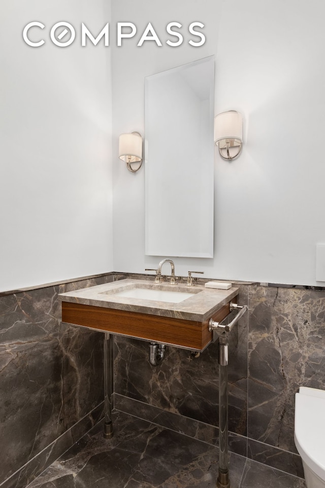 150 Charles St Unit 4An, New York City, NY 10014 - bathroom featuring tile walls, wainscoting, toilet, marble finish flooring, and vanity