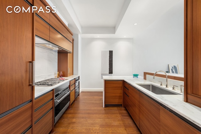 150 Charles St Unit 4An, New York City, NY 10014 - kitchen featuring brown cabinetry, dark wood-type flooring, modern cabinets, stainless steel appliances, and recessed lighting