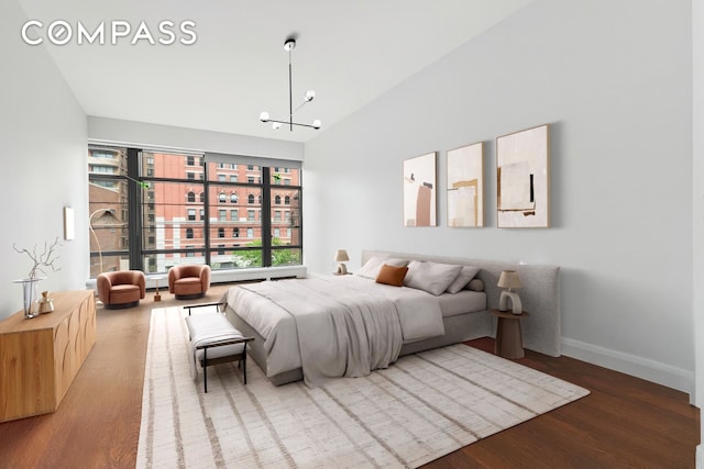 150 Charles St Unit 4An, New York City, NY 10014 - bedroom with wood finished floors, a chandelier, baseboards, and high vaulted ceiling