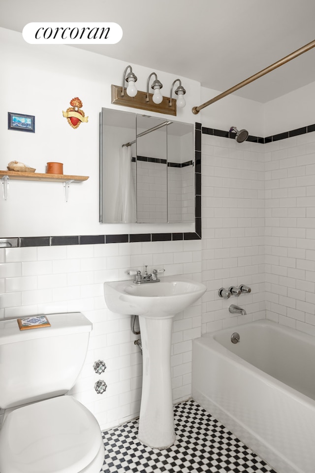 361 Clinton Ave Unit 5B, New York City, NY 11238 - bathroom with tile walls, shower / tub combo with curtain, and wainscoting