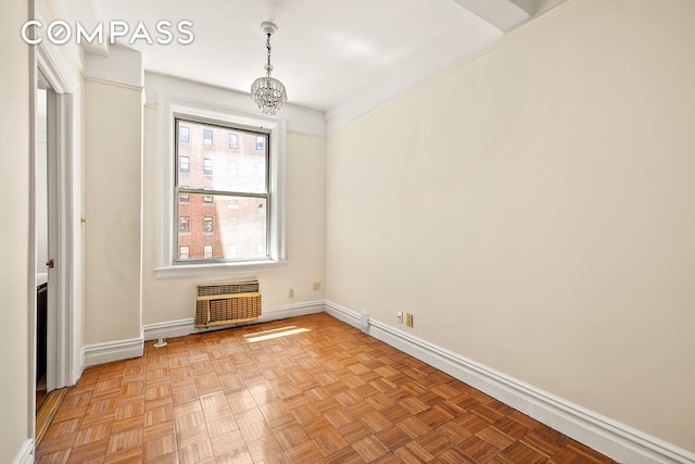 345 W 55th St Unit 8Ab, New York City, NY 10019 - spare room with a wall mounted air conditioner, a chandelier, and baseboards