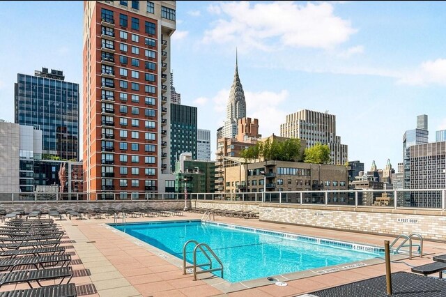 300 E 40th St Unit 24P, New York City, NY 10016 - community pool featuring a skyline view