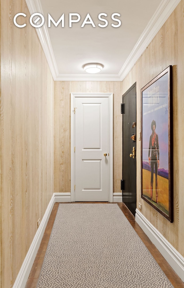 174 E 74th St Unit 3A, New York City, NY 10021 - hall featuring baseboards, dark wood-type flooring, crown molding, and wood walls