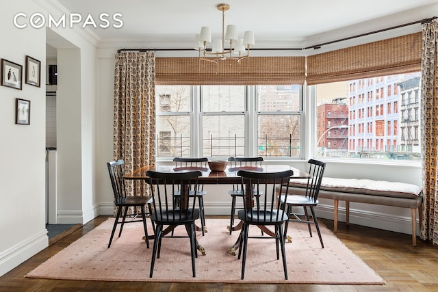 174 E 74th St Unit 3A, New York City, NY 10021 - dining room with crown molding, a chandelier, and baseboards
